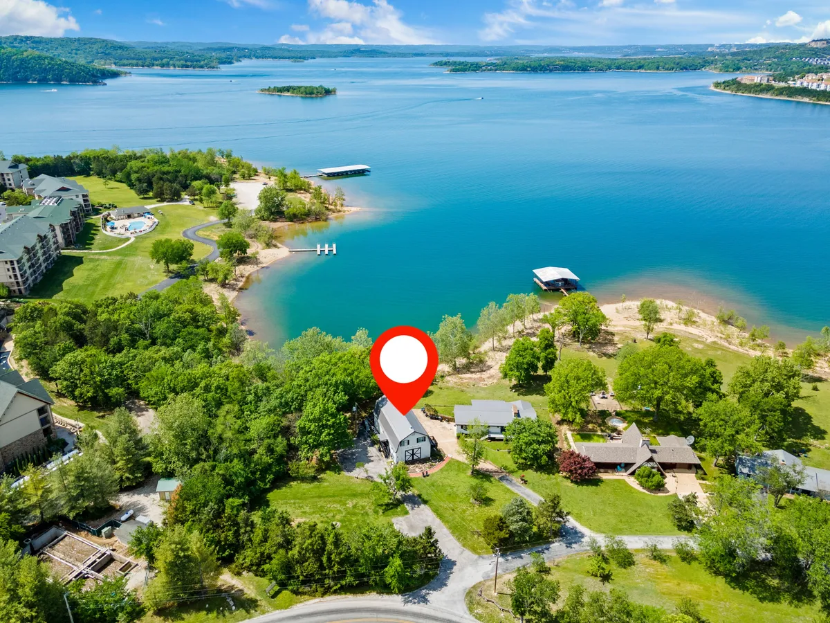 An inviting lakeside view that showcases the house, serene water, and lush greenery. The scene includes opportunities for boating, fishing, picnicking on the shore, and exploring nature trails, fostering a sense of adventure and relaxation.